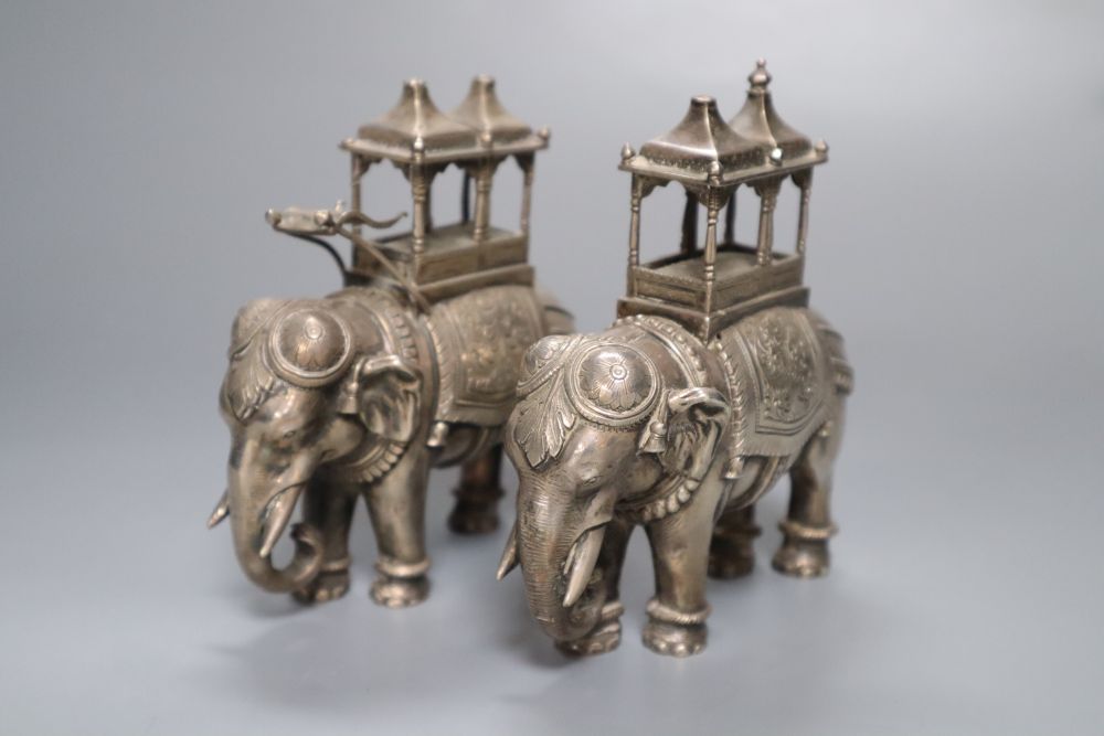 A pair of cast silver plated models of ceremonial elephants, 11cm high